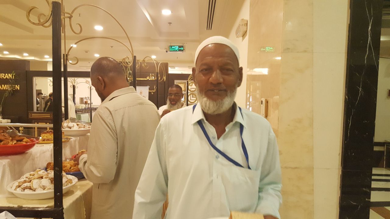 A contented pilgrim enjoying the buffet spread at the Haj and Umrah accommodation