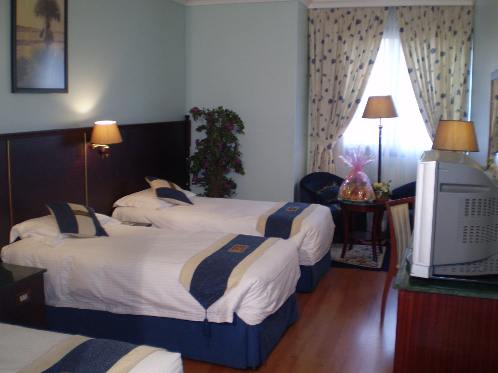 Comfortable twin-bed hotel room provided to pilgrims during their Umrah stay