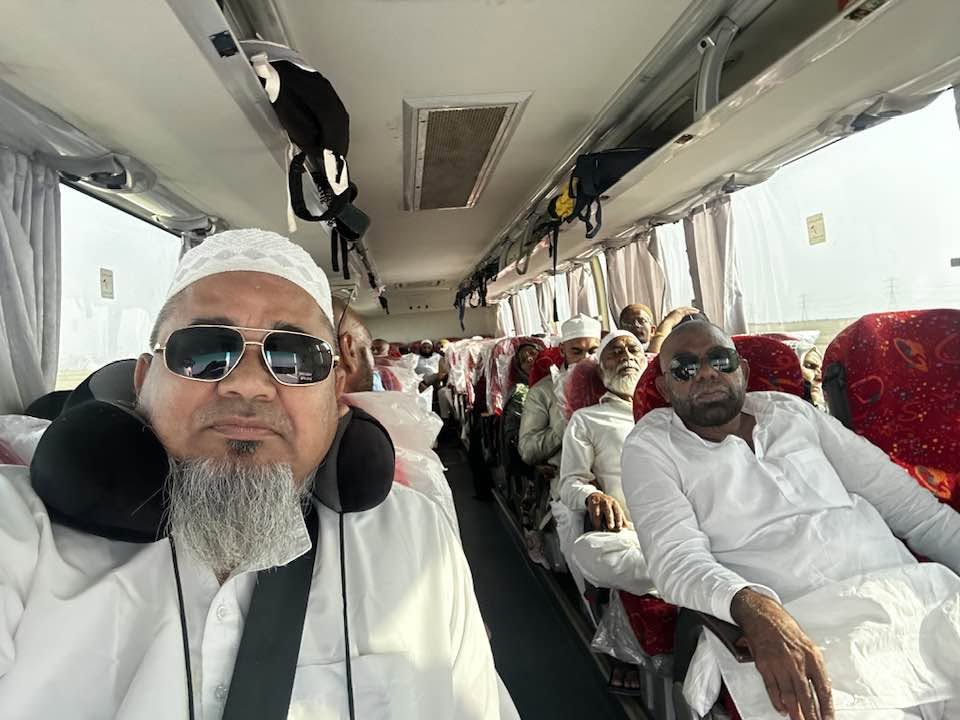Pilgrims seated in a luxury coach heading for guided Ziyaraat of holy sites